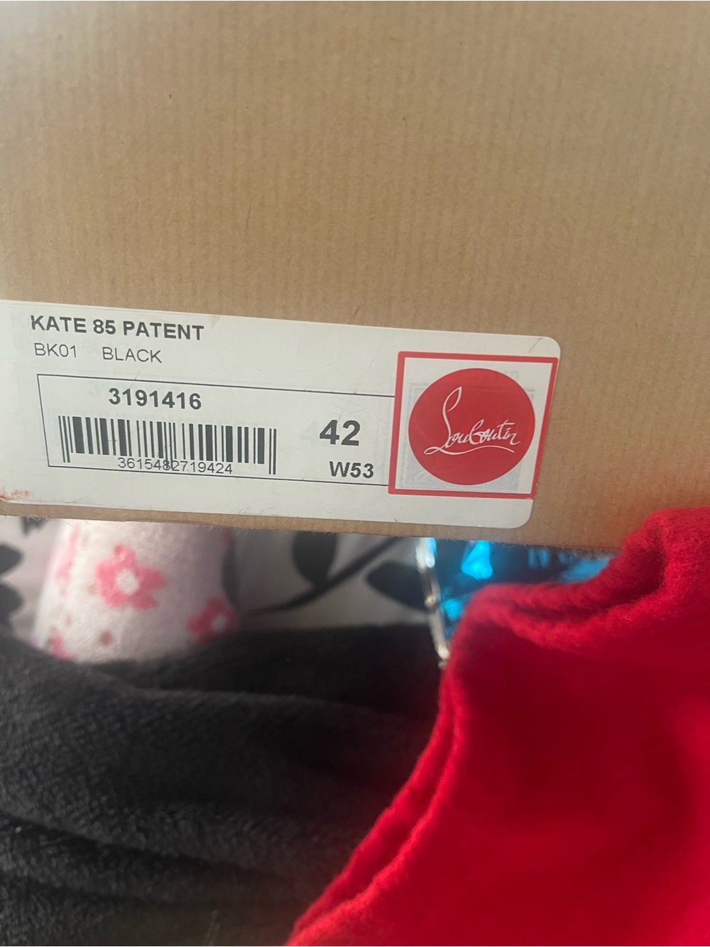 Christian Louboutin box label with red logo and red dust bag